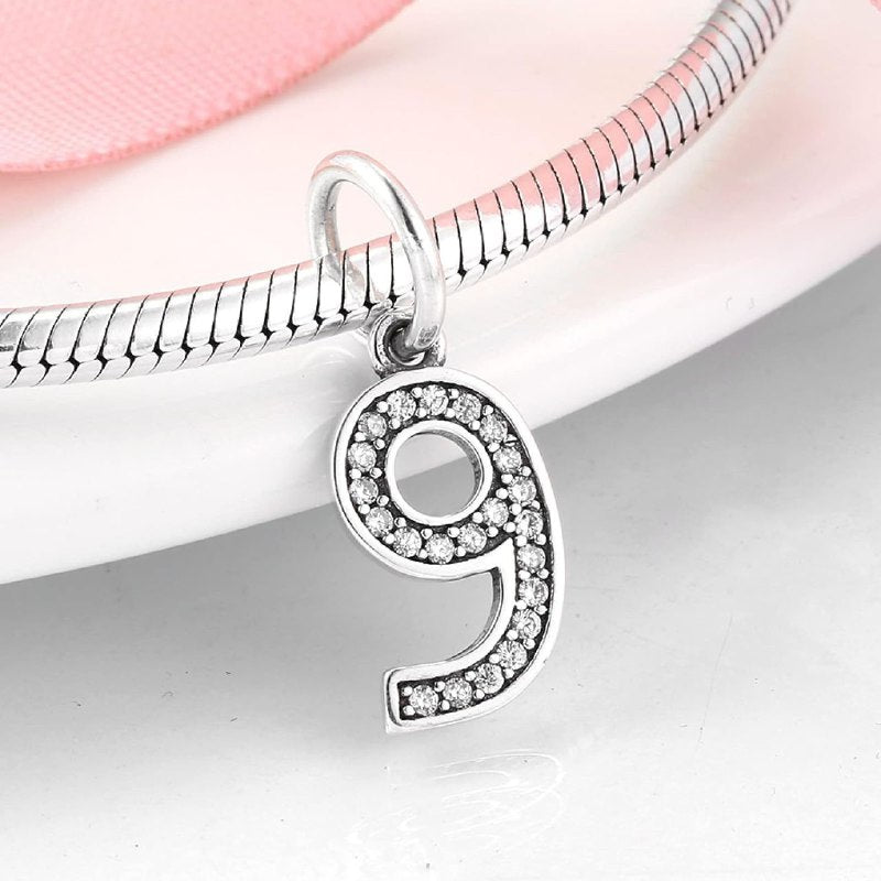 PCHARM4065$9 NUMERO 9 PANDORA PLATA 9.25